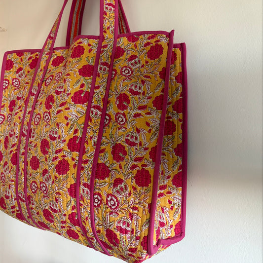 Floral patterned bag with pink trim on a white background