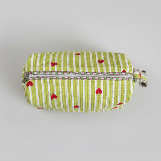 Quilted green and white make up bag with red hearts.