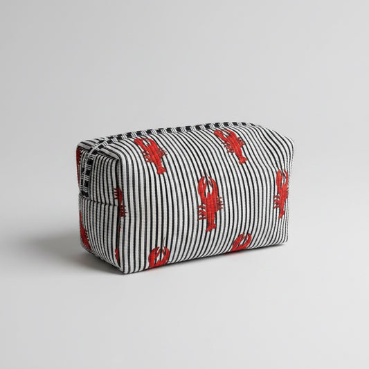 A striped fabric make up bag with red lobster prints.