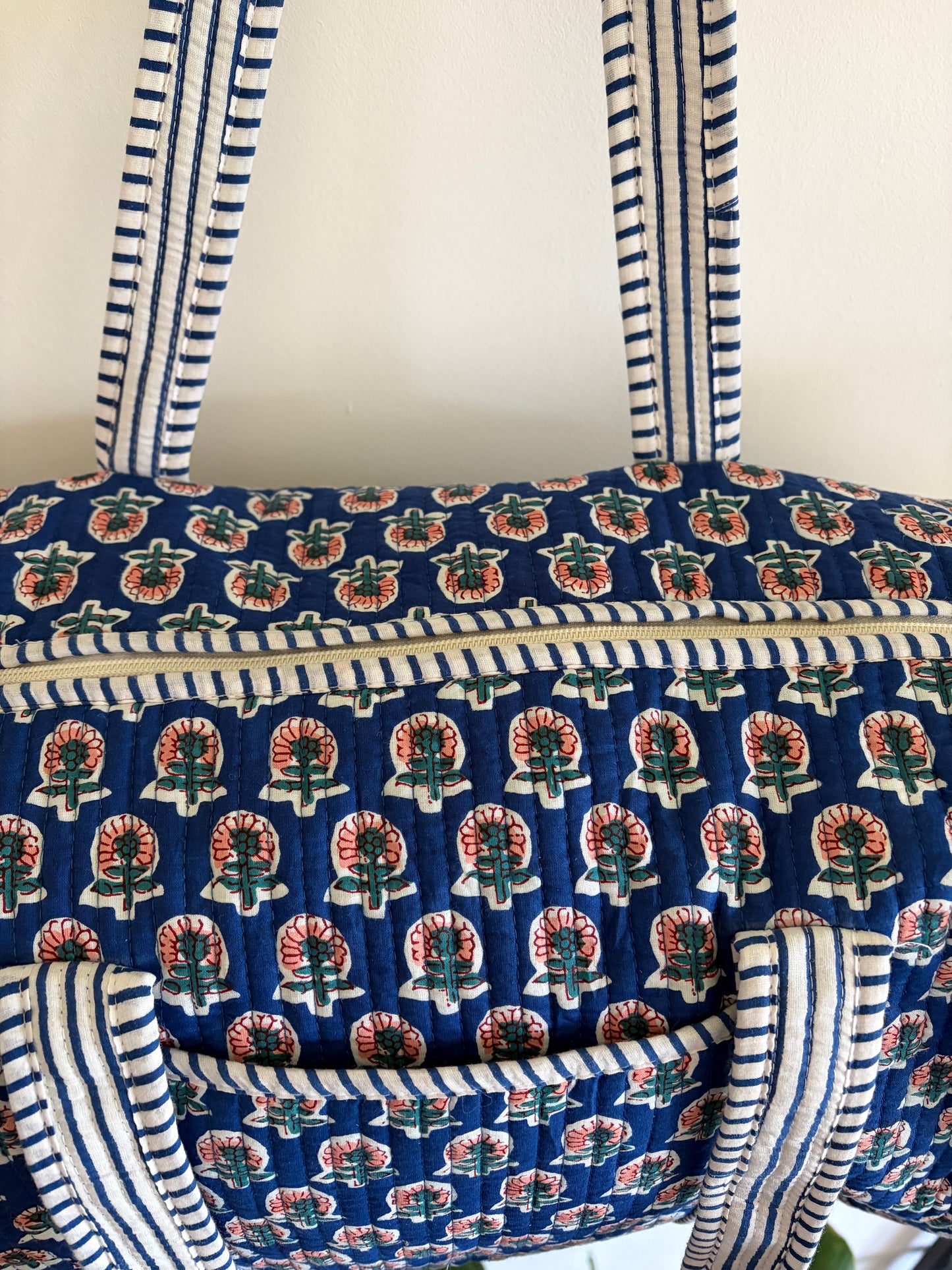 Blue quilted duffle bag UK close up fabric pattern detail