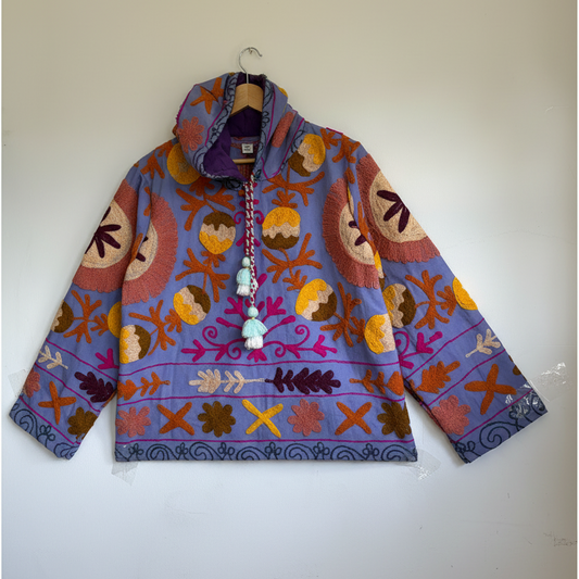A colorful patterned jacket with a high collar and decorative tassel.