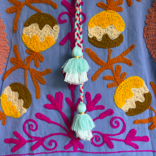 A purple hoodie with colorful suzani embroidery.