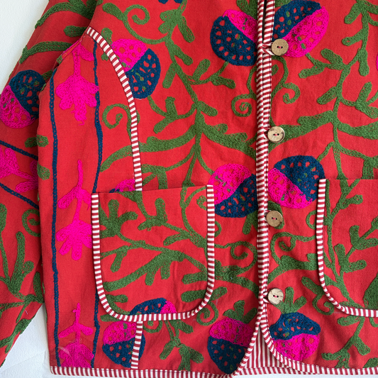 A red Suzani Embroidery jacket with a colorful floral and butterfly pattern.