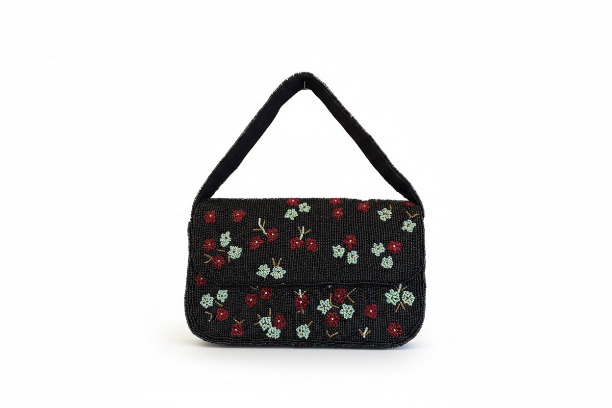 Black handbag with floral patterns on a white background