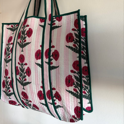 Floral patterned tote bag with green accents on a white background