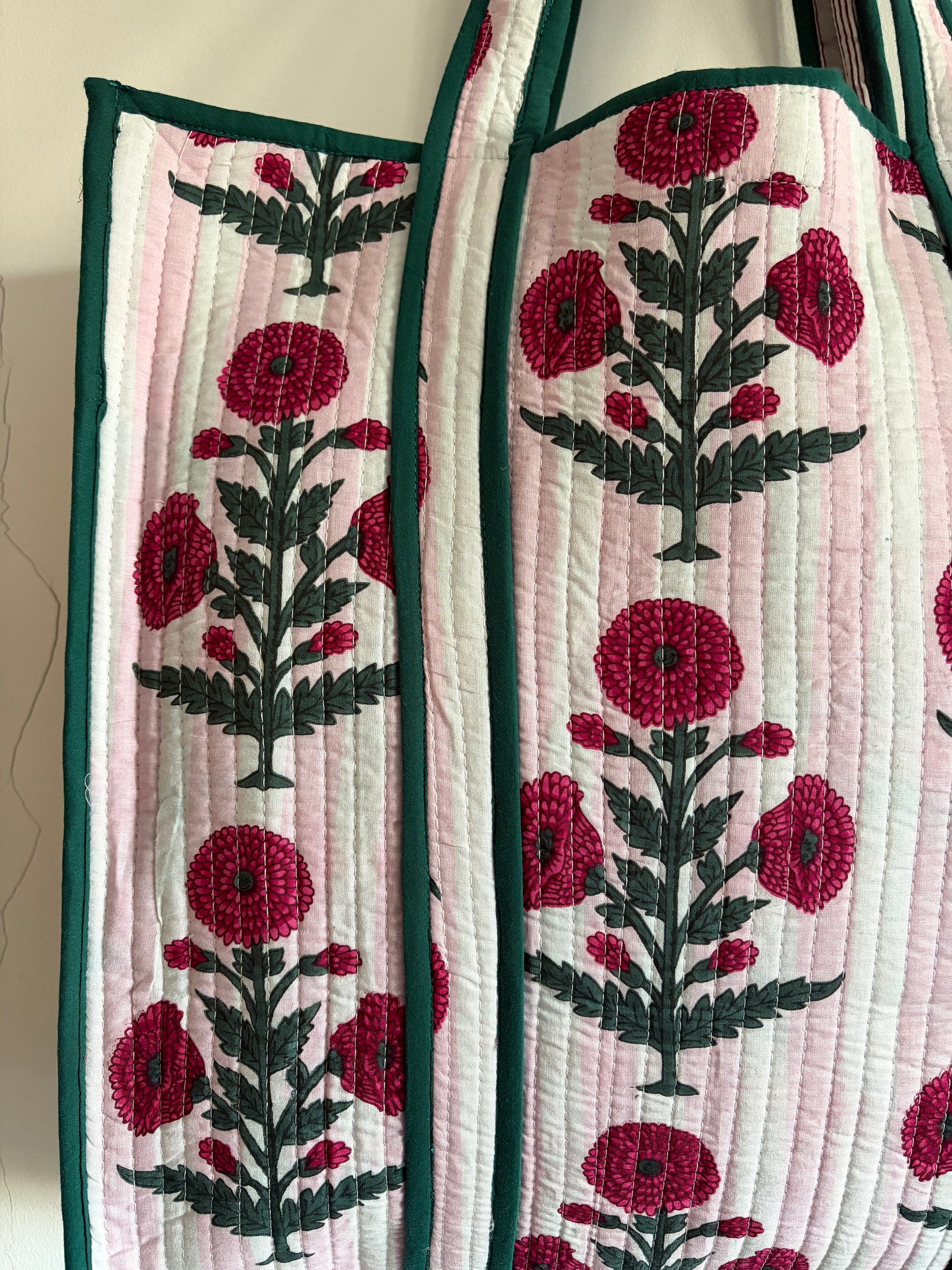 Quilted bag with floral embroidery on a mannequin