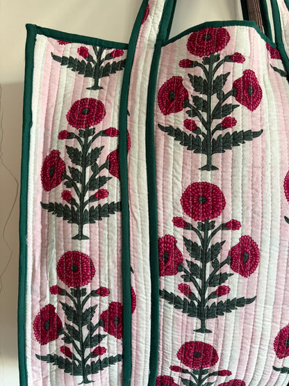 Quilted bag with floral embroidery on a mannequin