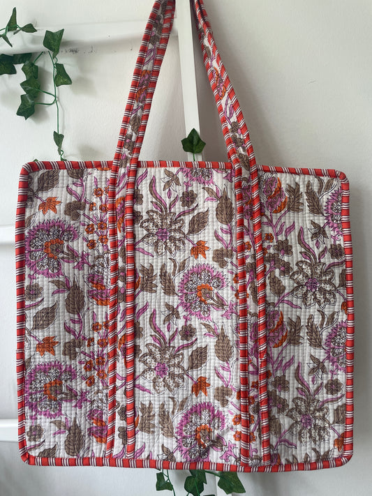 Floral patterned bag with a strap on a white background