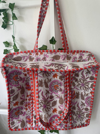 Floral patterned fabric with red and purple accents on a white background