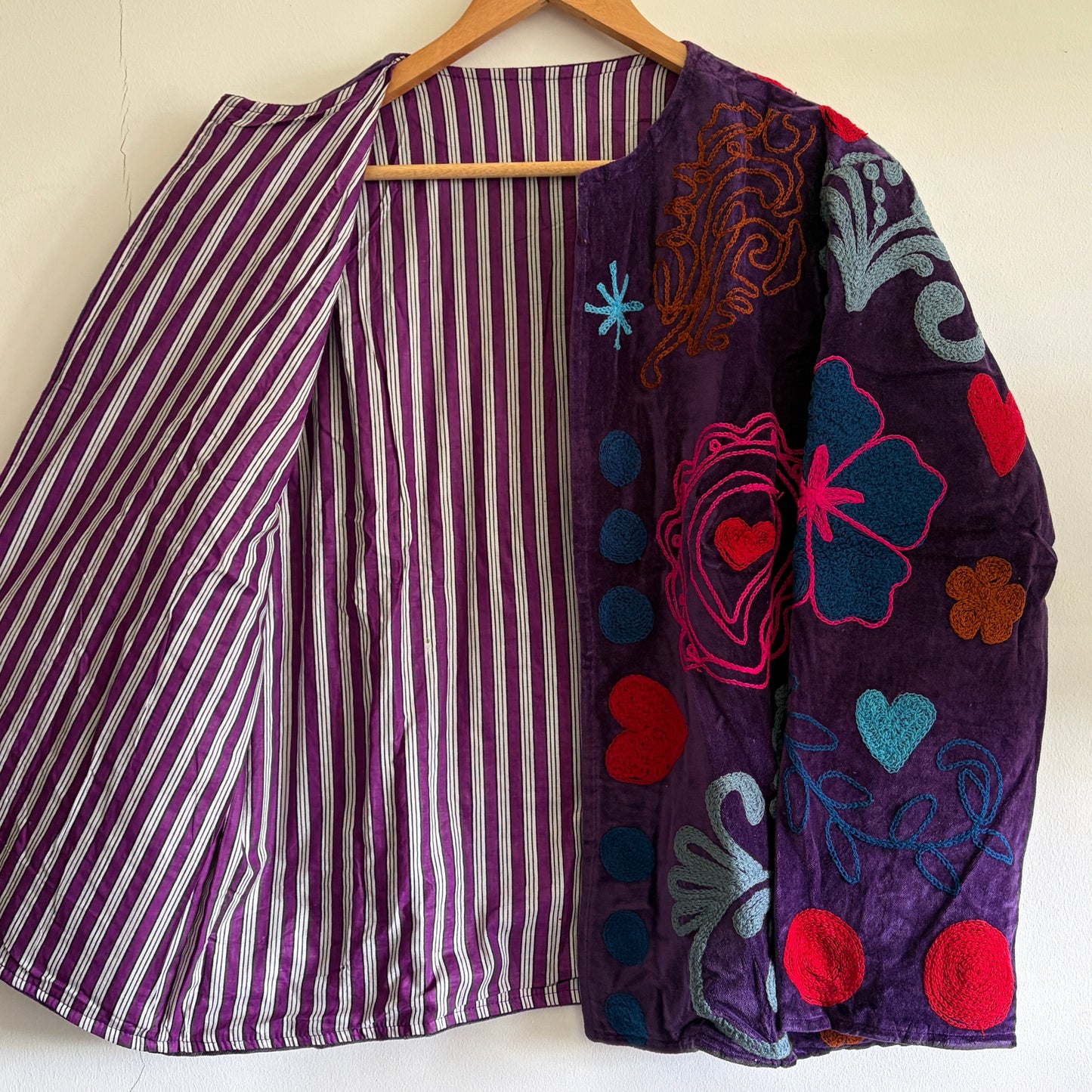 Purple Jacket with floral and striped patterns on a white background