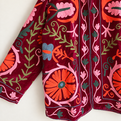 Burgundy velvet with coral and pink floral embroidery on this Suzani jacket