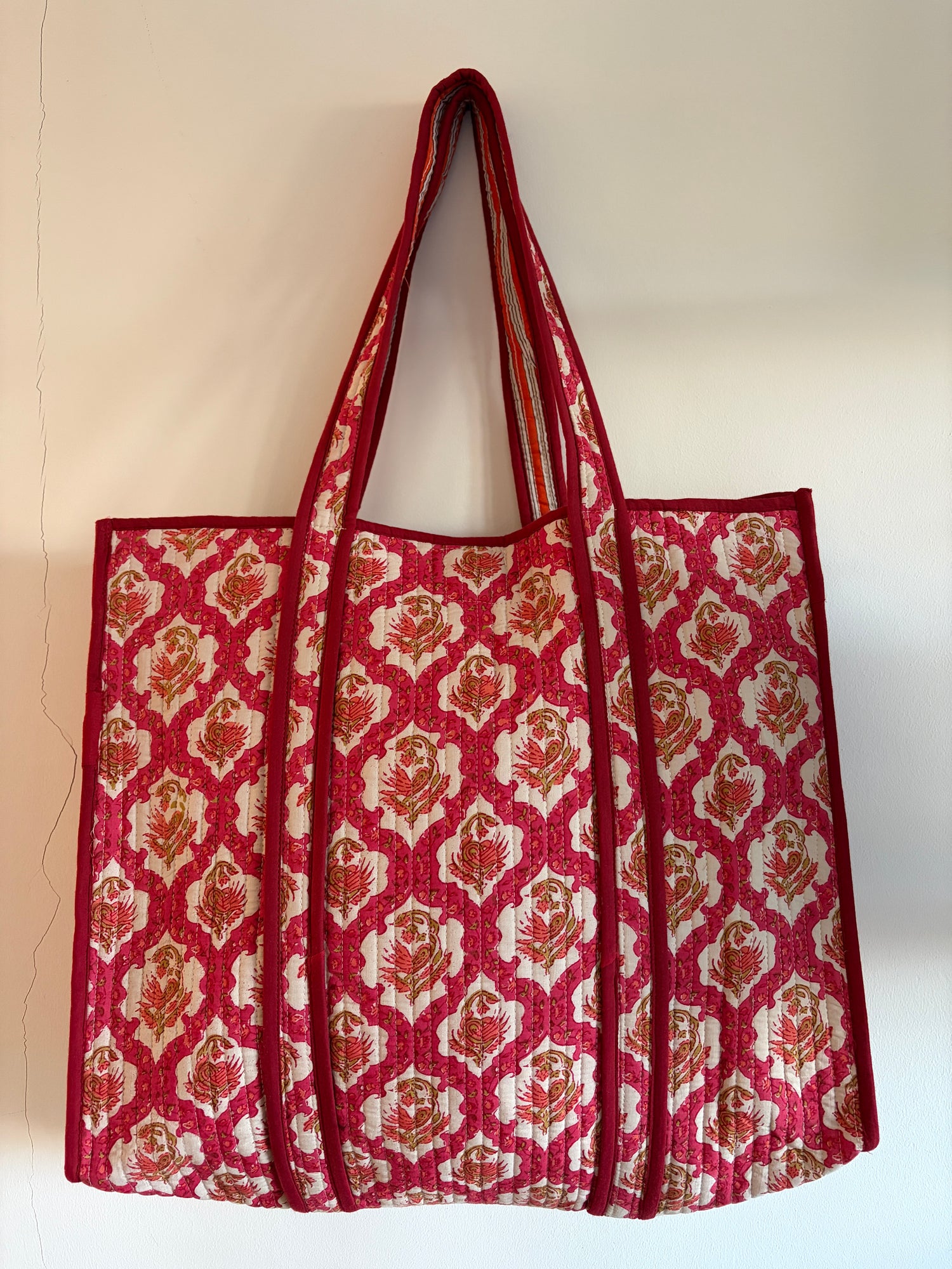 Red and white patterned bag on a beige background