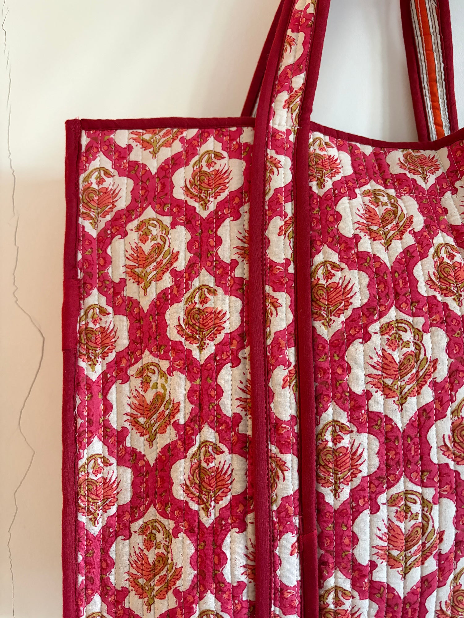 Red and white patterned fabric Bag with floral design on a white background