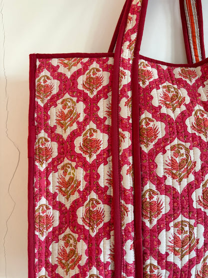 Red and white patterned fabric Bag with floral design on a white background
