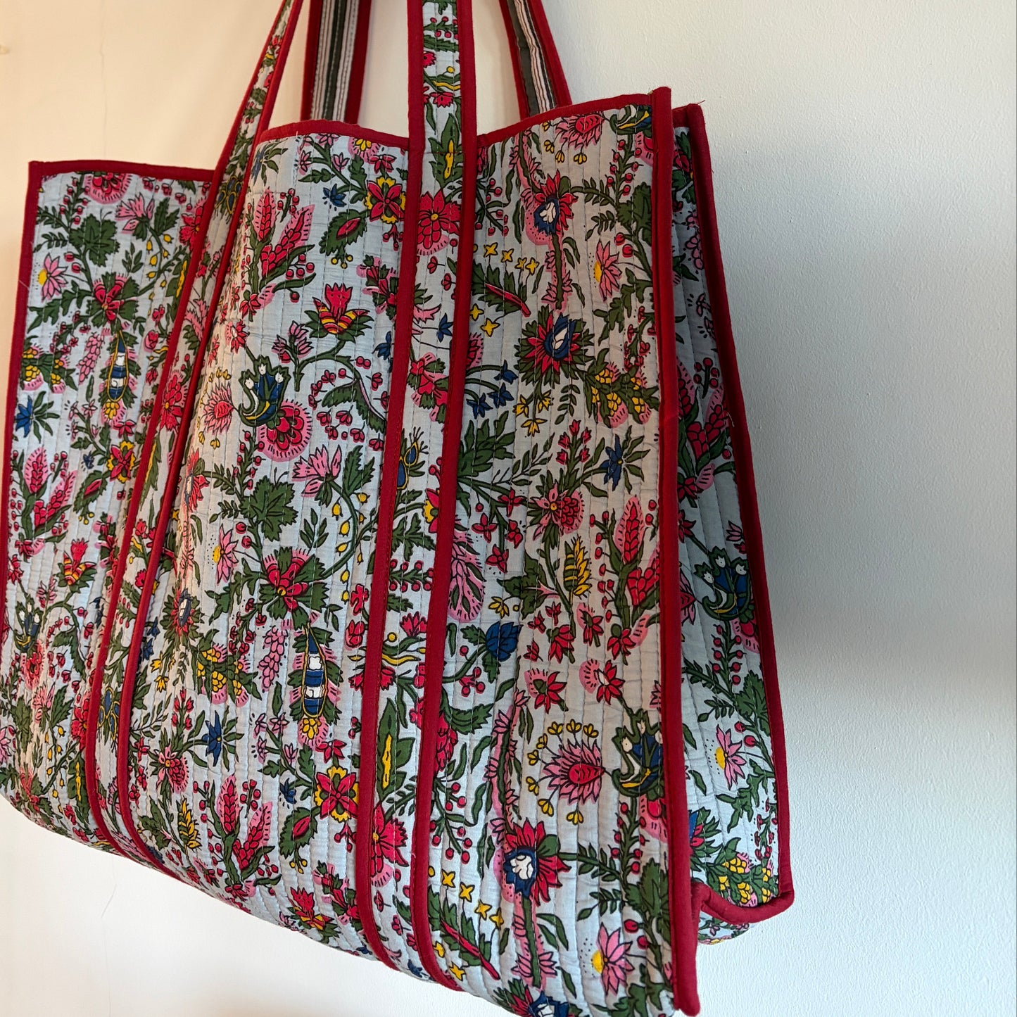 Floral-patterned Tote bag with red borders on a white background