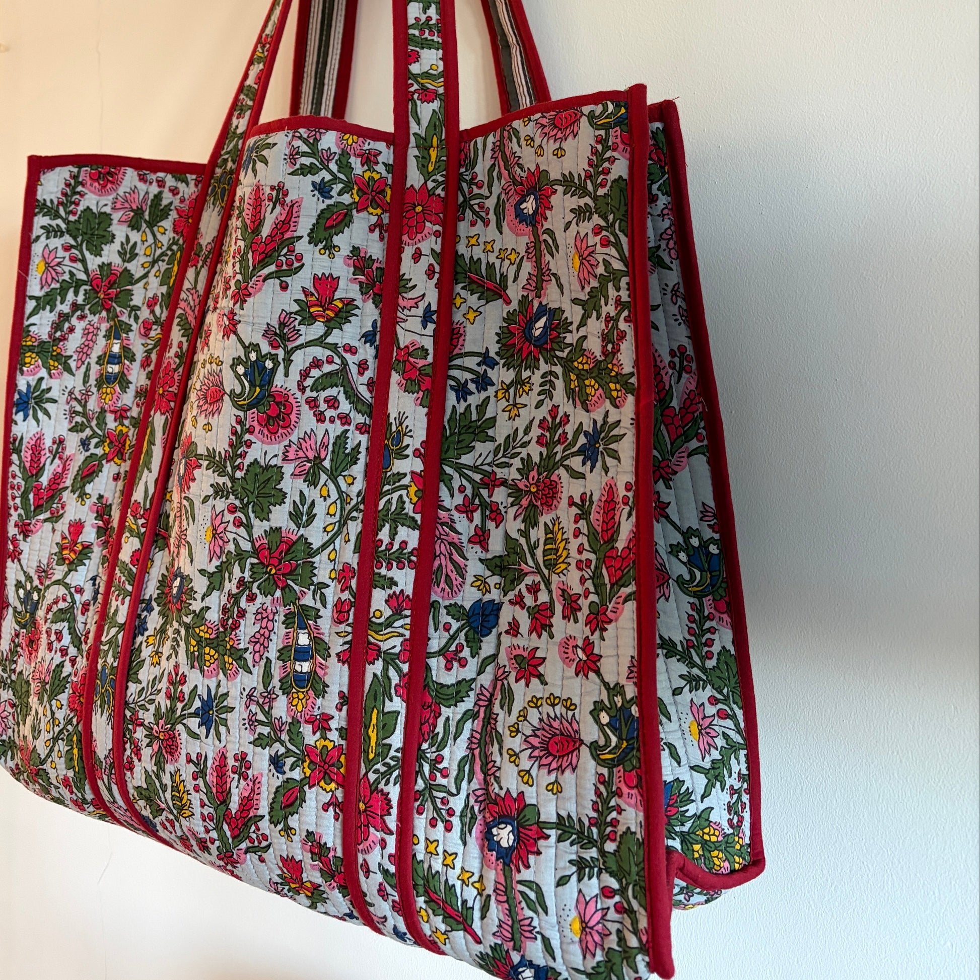 Floral-patterned Tote bag with red borders on a white background