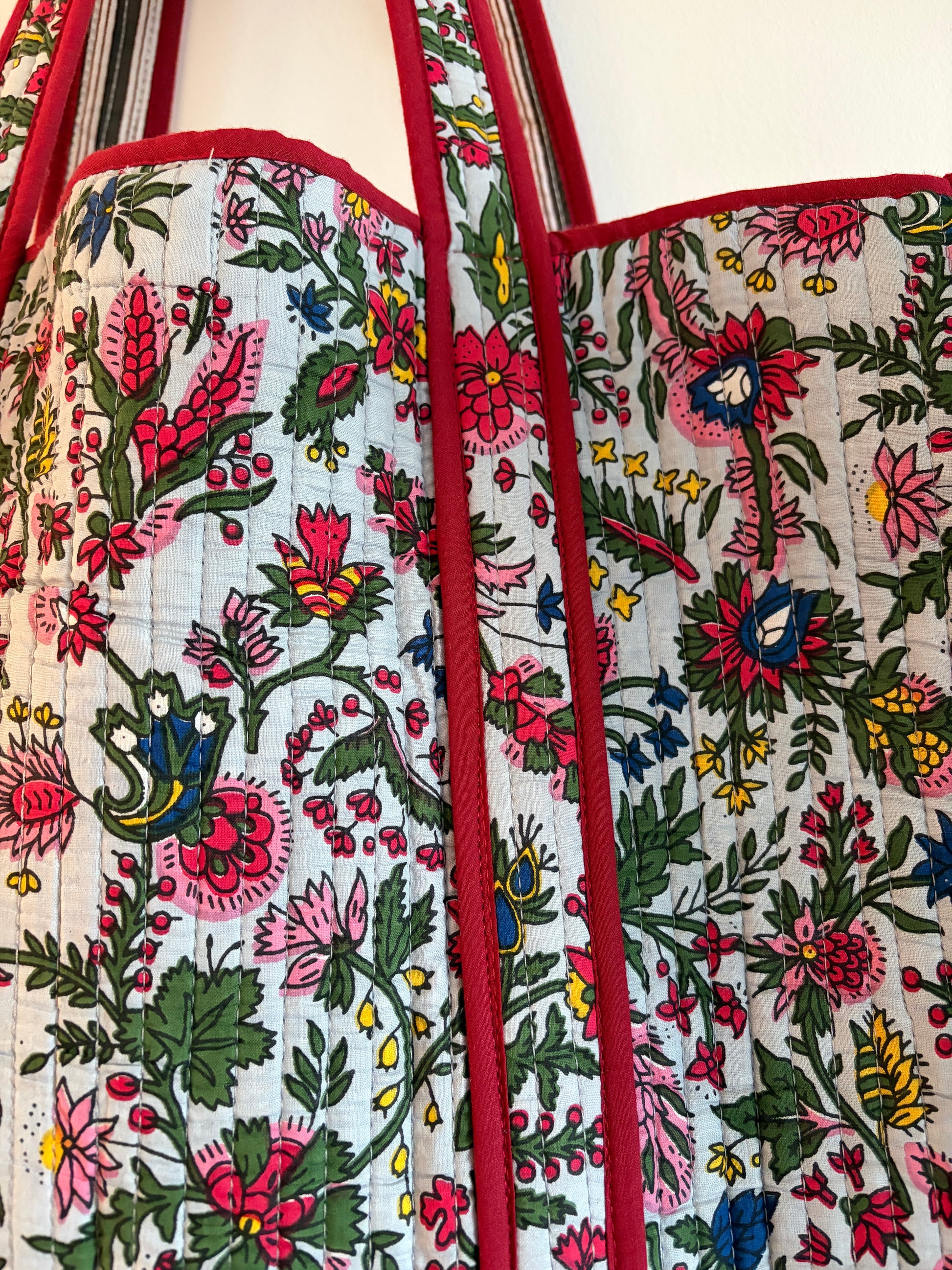 Floral patterned bag with red border on a white background