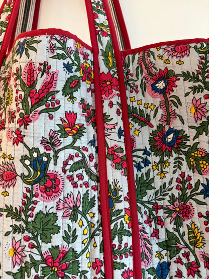 Floral patterned bag with red border on a white background