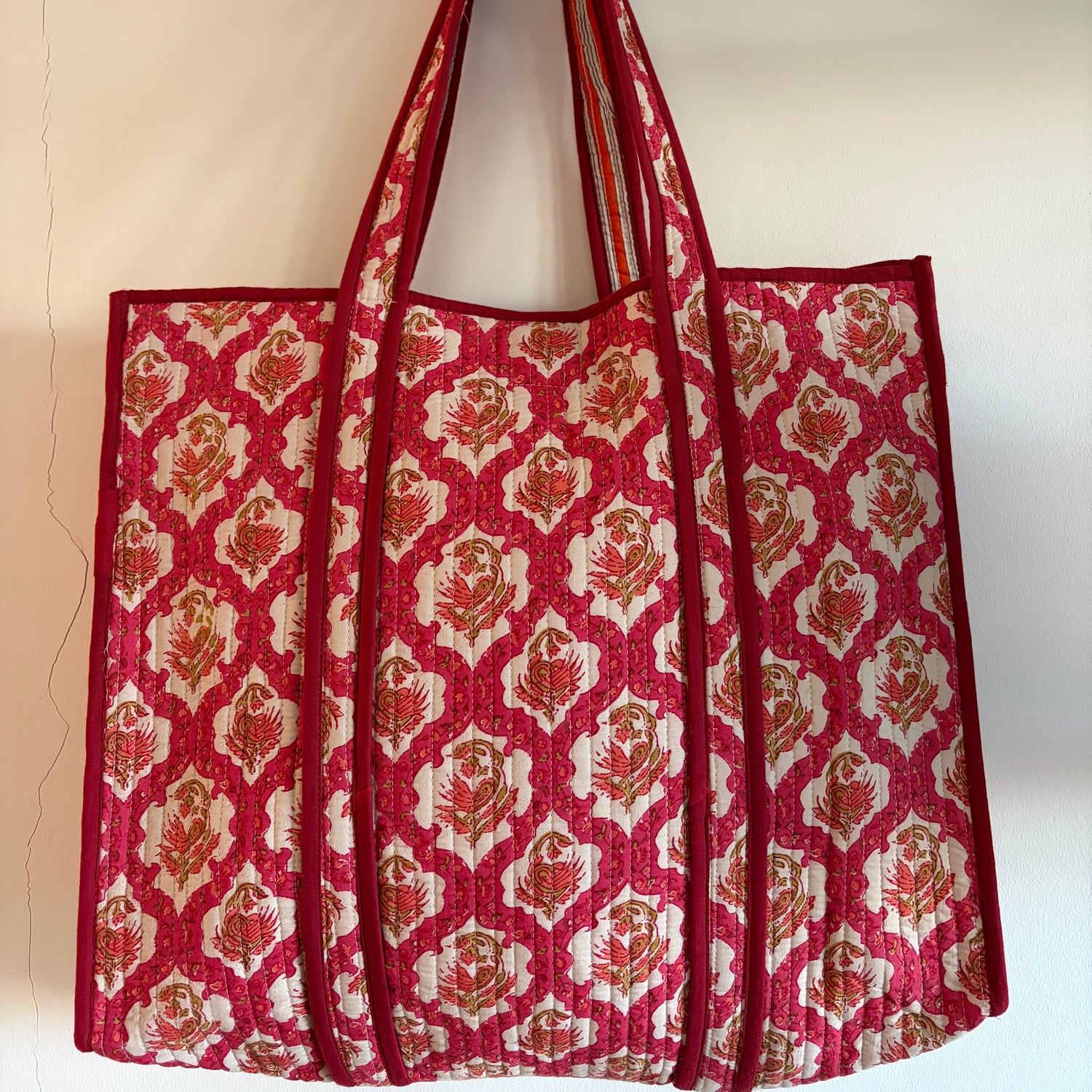 Red and white patterned bag on a beige background