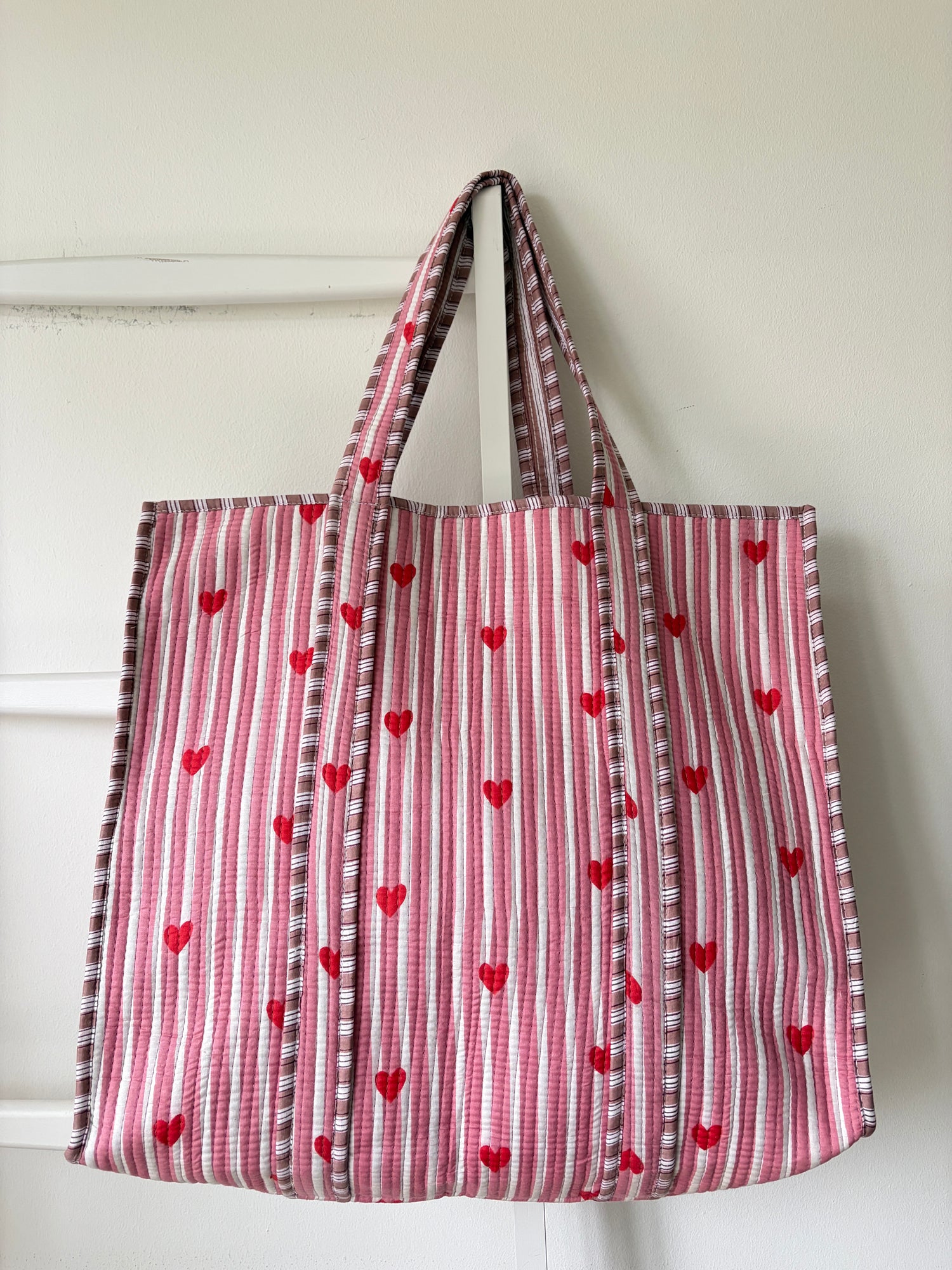Striped bag with heart patterns on a white background