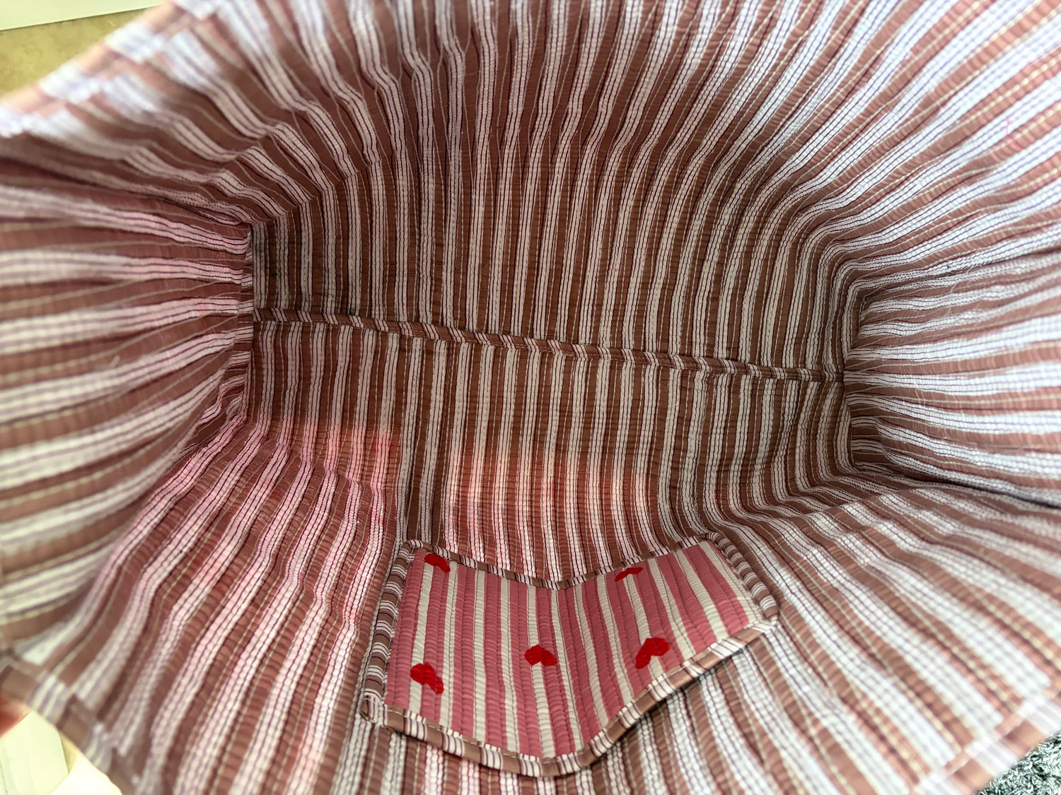 Close-up of a striped fabric interior with red accents