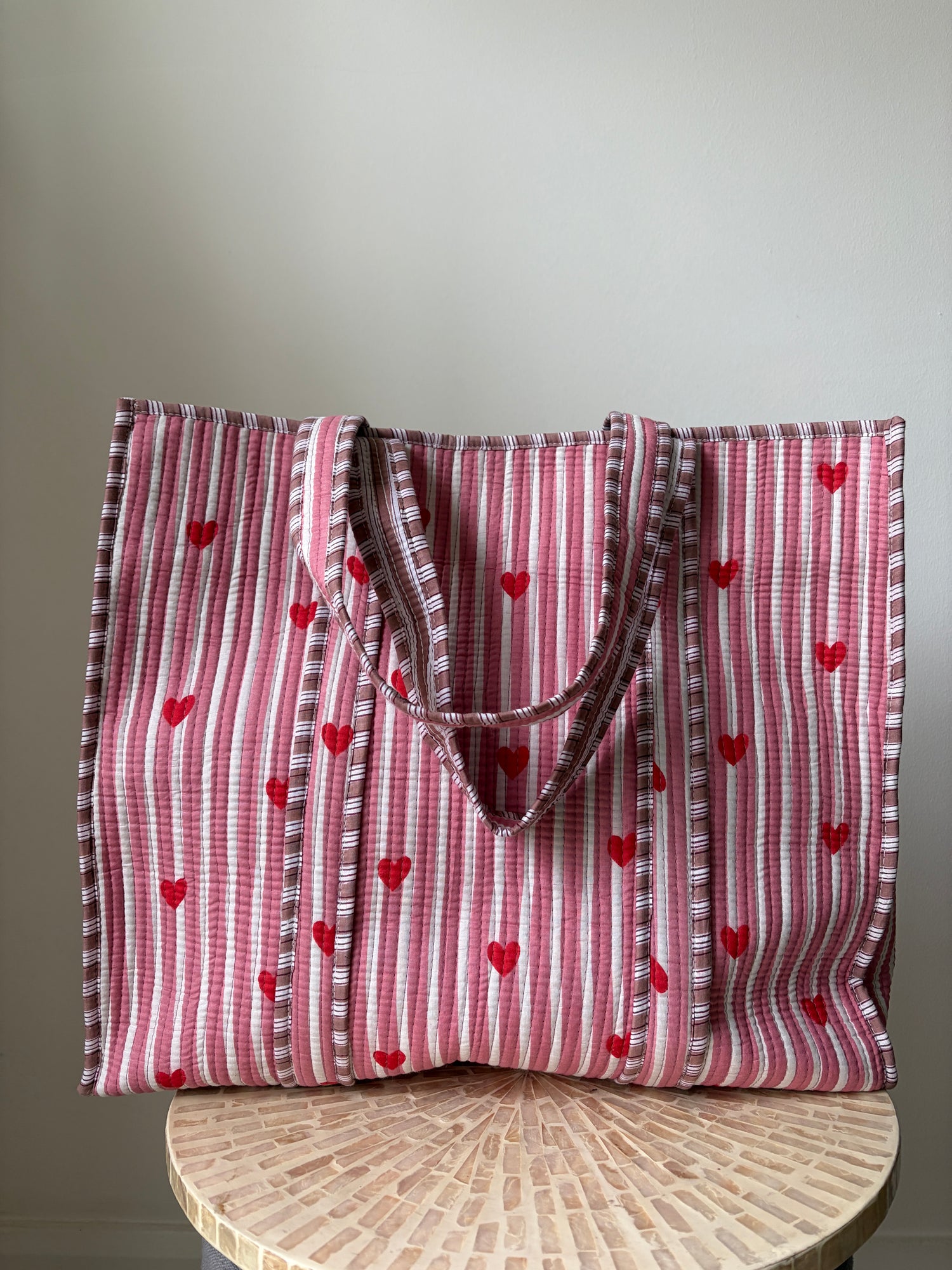 Red and white striped fabric Tote bag with heart patterns on a gray background