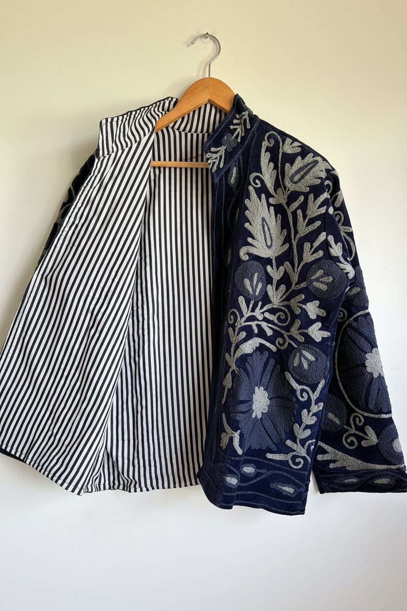 Navy blue embroidered Jacket with white patterns on a white background