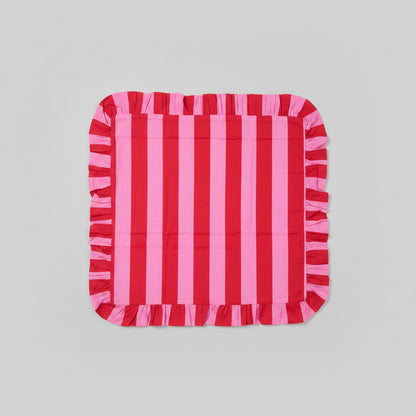 Red and pink striped cushion on a gray surface