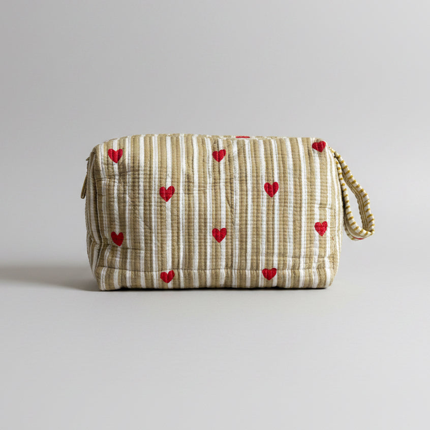 Quilted striped make up bag with red hearted pattern.