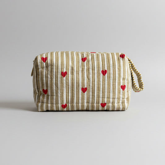 Quilted striped make up bag with red hearted pattern.