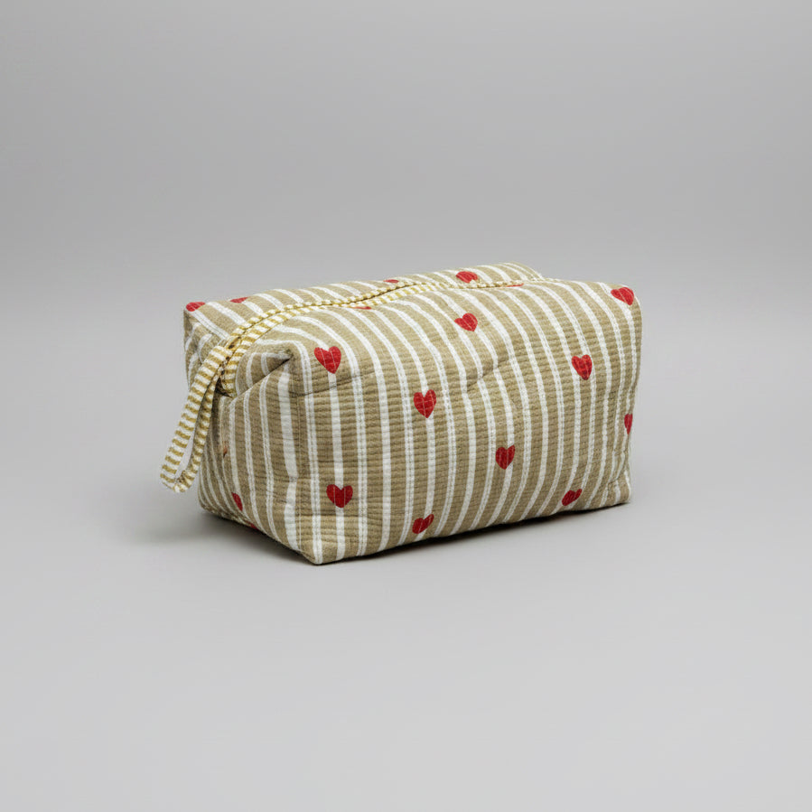 Quilted striped make up bag with red hearted pattern.