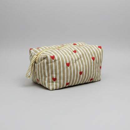 Quilted striped make up bag with red hearted pattern.