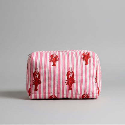 A pink and white striped cotton make up bag with red lobster prints.