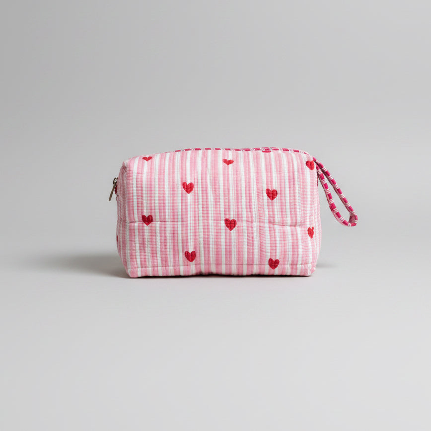 Quilted pink stripped tote bag with red hearted pattern.