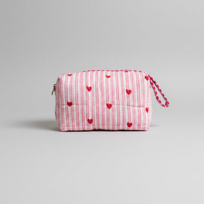 Quilted pink stripped tote bag with red hearted pattern.