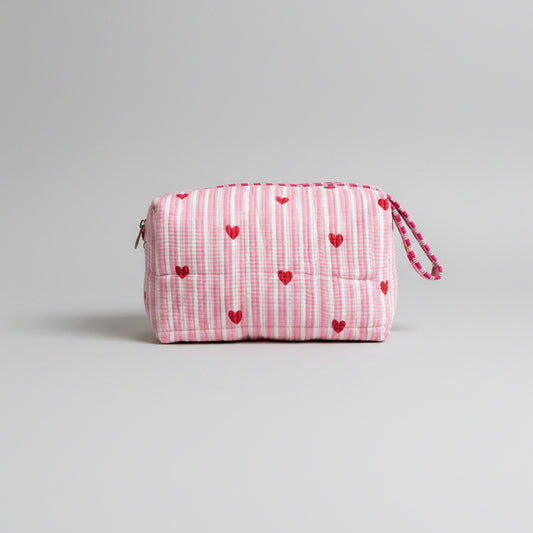 Quilted pink stripped tote bag with red hearted pattern.