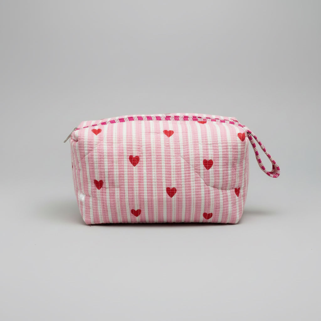 Quilted pink stripped tote bag with red hearted pattern.