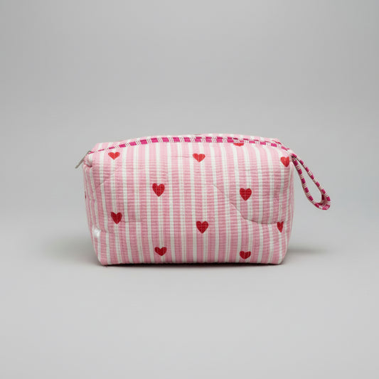 Quilted pink stripped tote bag with red hearted pattern.