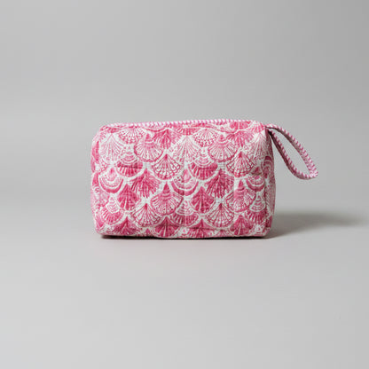 A pink and white patterned zippered make up bag with a matching loop handle.