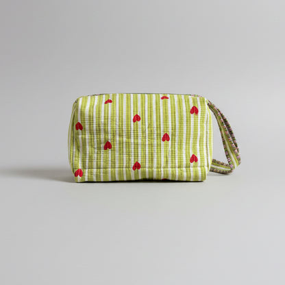 Quilted green and white make up bag with red hearts.