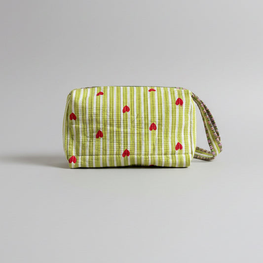 Quilted green and white make up bag with red hearts.