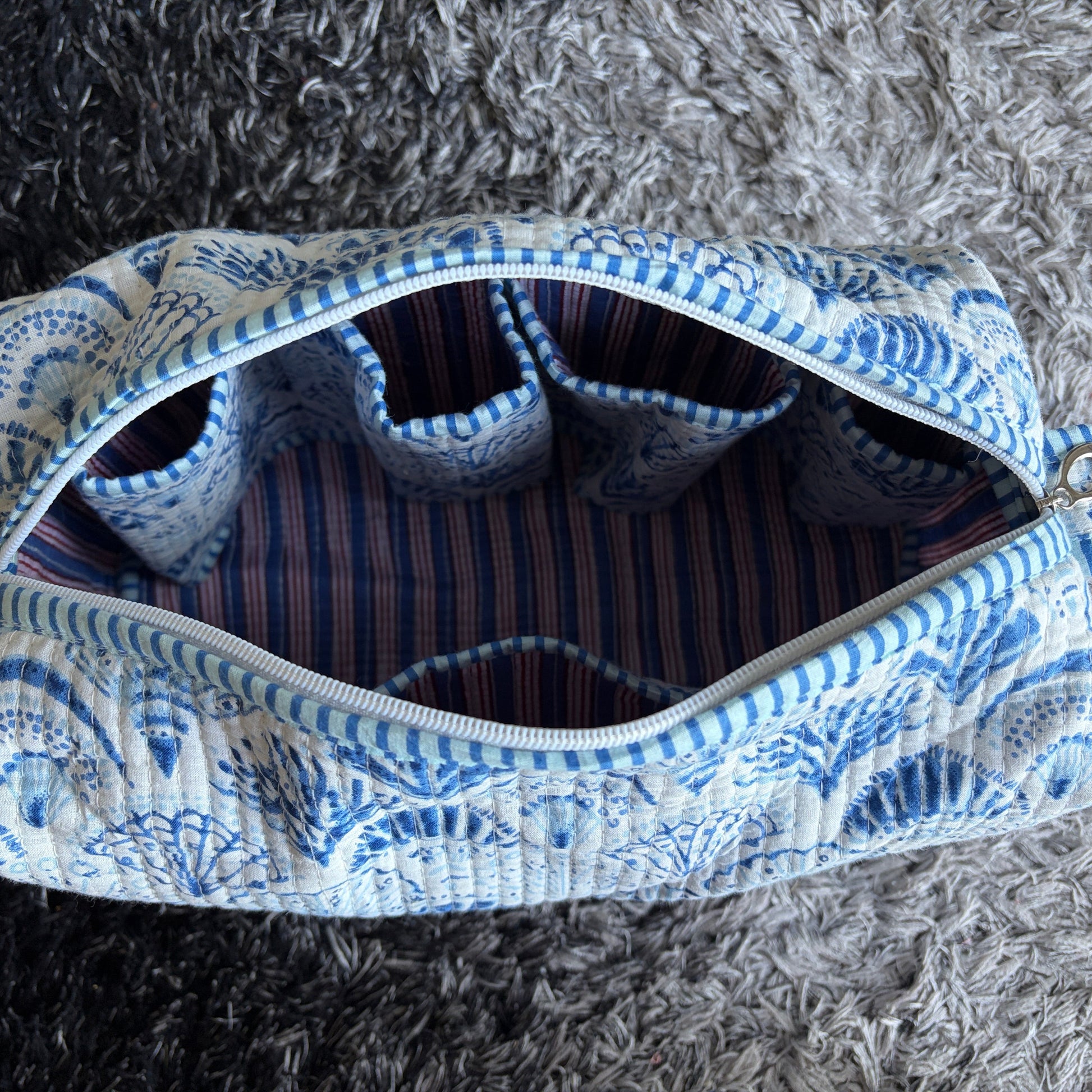 Quilted Cotton make up  bag with a blue and white shell design.