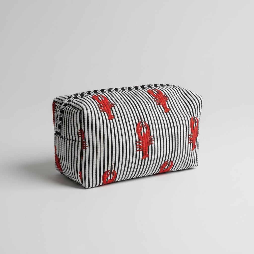 A striped fabric make up bag with red lobster prints.