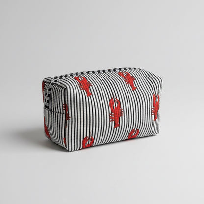 A striped fabric make up bag with red lobster prints.