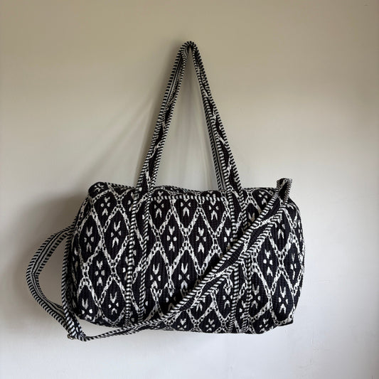 black and white patterned cotton quilted duffle bag