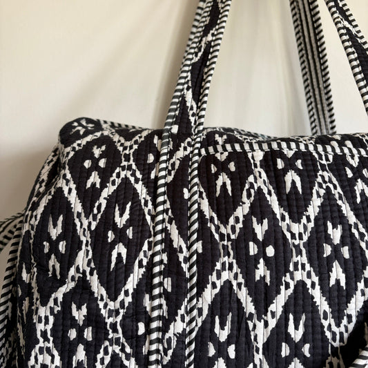 black and white patterned cotton quilted duffle bag