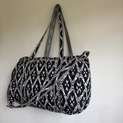 black and white patterned cotton quilted duffle bag