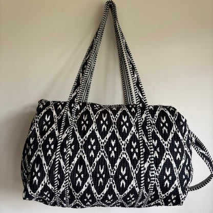 black and white patterned cotton quilted duffle bag