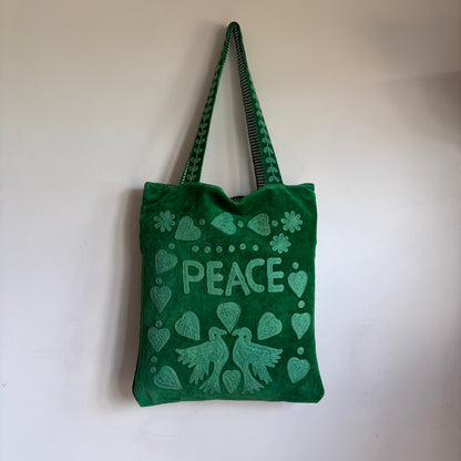Green Suzani Velvet bag with blue hearts and 'LOVE' on a beige background