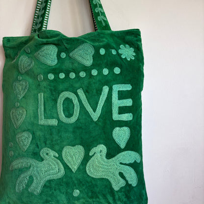Green Suzani Velvet bag with blue hearts and 'LOVE' on a beige background